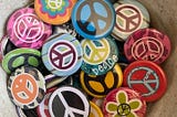 Colorful peace sign buttons to represent the peace and love logo developed in 1958.