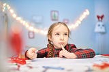 A young girl thinking of a good swear word.