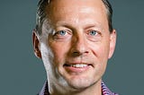 Color photo of Eric Wrobel, a White man with blue eyes and plaid shirt, Head of Product at Blend.