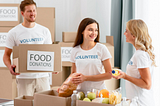 A photo of three young people who are preparing boxes of food donations at a food bank.
