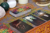 Tarot cards & mystic accoutrements set out on a table