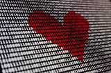 tlb Blog Post on Medium: AI for Startup Success — Computer Screen with Heart Image in 1’s and 0's
