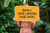 Woman holds up “your landing page sucks” sign.