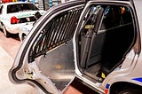 a open door to a police car inviting someone in, Trump, immigrants, depoetation