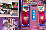A picture of Kinky’s Dessert Bar’s door, wall decor, and some of there desserts
