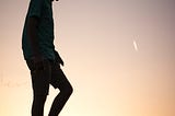 A man walking alone at sunset