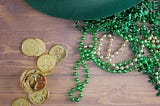 Photo of St. Patrick’s day hat, beads and coins.