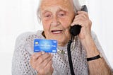 Photo of woman giving her credit card details over the phone.