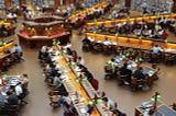 Students learning in a large library