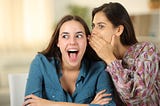 Two women gossiping.