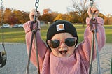 Photo of a kid with a victorious smile on her face.