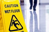 caution wet floor sign — from Make Better Decisions — Why Managers Violate Natural Laws by Truby Achievements