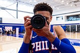 A basketball player on the court prepares to take a picture.