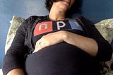 An NPR T-shirt stretched over my pregnant belly.