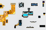 Blue and Yellow Phone Modules laid out on a light grey background