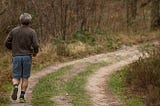 man jogging on a trail