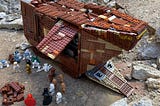 Star Wars Sand Crawler with a bunch of bricks and characters. Boba Fett fell over, and it’s meant to show a lot from a little