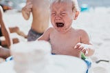 child crying birthday cake