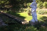 An image of a garden with a statue