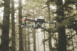 A drone flying through a forest