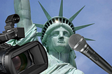 The Statue of Liberty with a microphone and camera in front of it