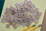 Scrabble letters spelling out “back to school”.