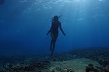 A woman dives underwater