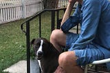 Older lady with dog on stoop