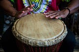 A photo of hands poised in position to start playing a drum