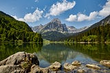 A mountain reflects off the surface of a lake in Switzerland