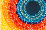 Tightly patterned dabs of paint form vibrant concentric circles in colors from yellow to red to blue, with a deep black center.