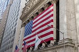 A photo of the New York Stock Exchange draped in an American flag