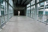 Man walking in hallway of empty office building