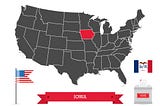 Map of the U.S. showing Iowa in red with the image of a ballot box and an American flag beneath it.