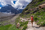 Person Walking on Mountain. How to maximize fat loss when walking. How to use walking to finally lose fat.