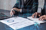 The image shows a professional setting where a person is engaged in analytical work. They appear to be a business professional, examining documents and data while working on a computer keyboard with a laptop open beside them. Overlaying this scene are digital graphics symbolizing data connections and network interactions, suggesting a focus on technology, data analysis, or cyber operations. The overall impression is one of modern business analysis or data management