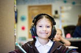 headphones on a girl in a classroom