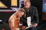 Drake Maverick signing an NXT contract with Triple H
