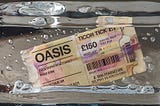 A concert ticket for Oasis frozen in a block of ice