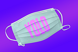 A surgical mask with the letters Y O L O printed on it over a purple and pink background