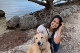 Angie and her golden retriever by the water.