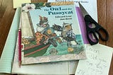 Copy of Owl and the Pussycat by Edward Lear, illustrations by Jan Brett, with notes and scissors indicating someone is making comments about it.