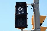 A traffic signal indicating “walk”.