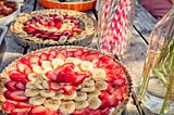 Birthday fruit tarts on a picnic table