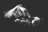 Grey scale photo of senior hands counting money.