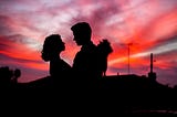 couple looking at each other in sunset