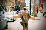 A delivery driver carrying parcels