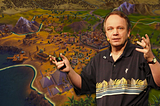 Sid Meier presenting a keynote with an edited background of his game, Civilization.