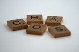 Scrabble tiles spelling the word ‘chaos’