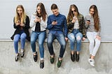 Group of teenagers outdoors with mobile phones